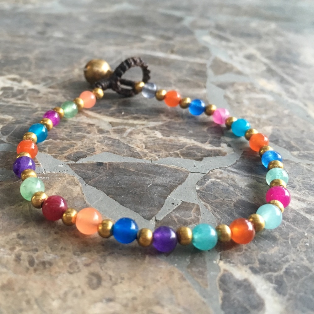 Hand woven beaded boho bracelet with brass bell